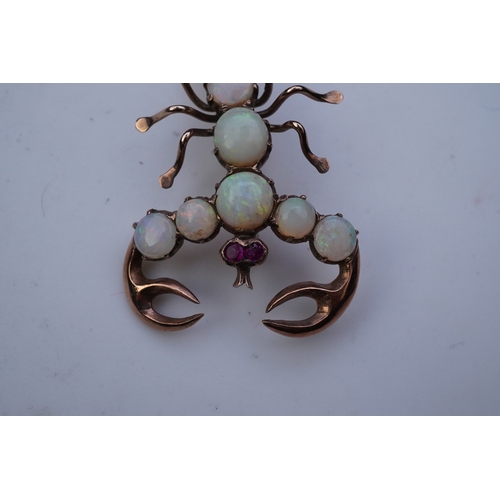 225 - An opal brooch, mid 20th century, designed as a scorpion, its body set with cabochon opals, its eyes... 