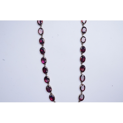 226 - A garnet rivière necklace, circa 1970, designed in the Georgian style, composed of links set with fl... 