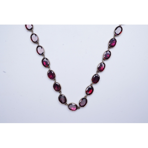 226 - A garnet rivière necklace, circa 1970, designed in the Georgian style, composed of links set with fl... 