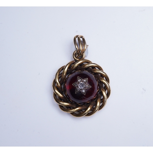 227 - A Victorian garnet and diamond pendant, mid 19th century set with a cabochon garnet inlaid with a st... 