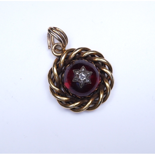 227 - A Victorian garnet and diamond pendant, mid 19th century set with a cabochon garnet inlaid with a st... 