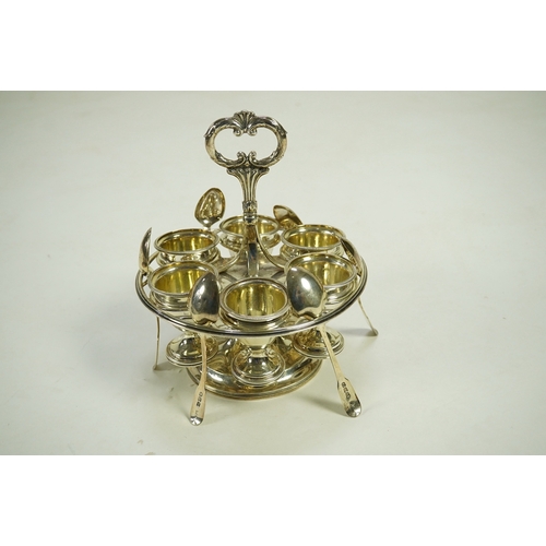 23 - A George III silver egg cruet stand, with six egg cups and six spoons (one not matching), by Solomon... 