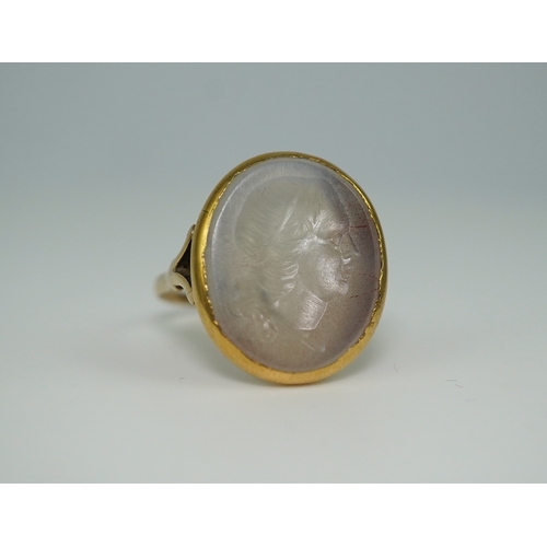 231 - A chalcedony intaglio ring, early 19th century, set with a pale chalcedony intaglio depicting a lady... 