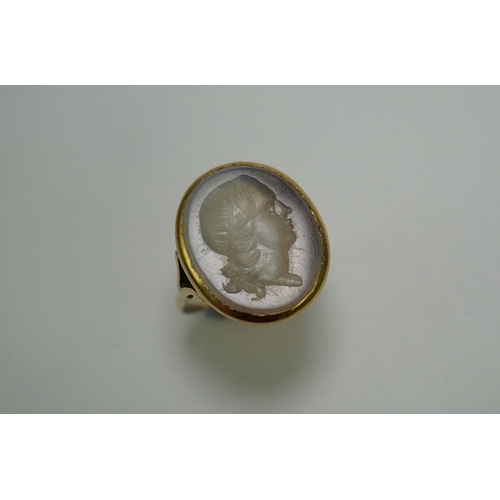 231 - A chalcedony intaglio ring, early 19th century, set with a pale chalcedony intaglio depicting a lady... 