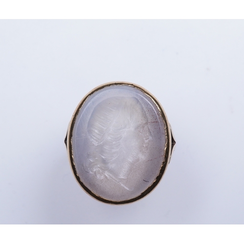 231 - A chalcedony intaglio ring, early 19th century, set with a pale chalcedony intaglio depicting a lady... 