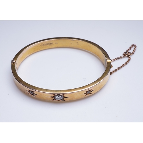 232 - An Edwardian 15ct gold and diamond bangle, circa 1904, the hinged bangle set to the front with a seq... 