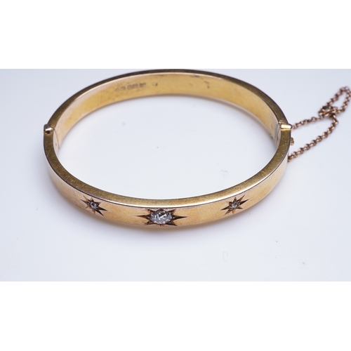 232 - An Edwardian 15ct gold and diamond bangle, circa 1904, the hinged bangle set to the front with a seq... 