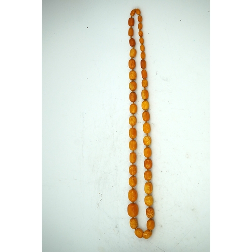 234 - A single strand graduated oval amber bead necklace, length 104cm, gross weight 163 grams