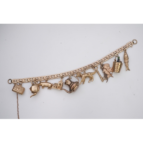 243 - A charm bracelet, mid 20th century, the 9ct gate link bracelet suspending a series of twelve charms ... 