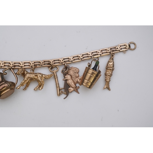 243 - A charm bracelet, mid 20th century, the 9ct gate link bracelet suspending a series of twelve charms ... 