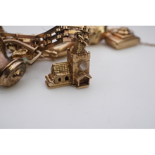 243 - A charm bracelet, mid 20th century, the 9ct gate link bracelet suspending a series of twelve charms ... 