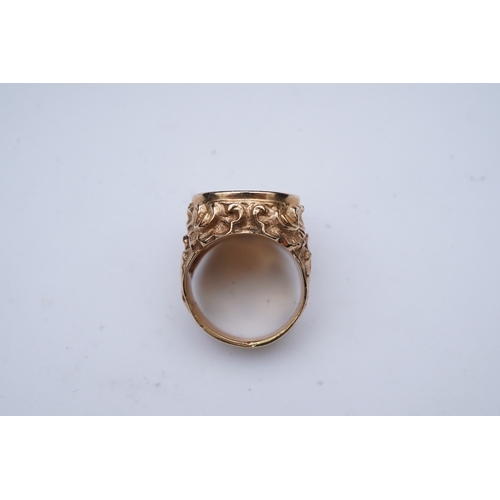 245 - A gold peso coin ring, set with a Mexican 2.5 peso coin dated 1945, in an elaborate gold mount of Ba... 