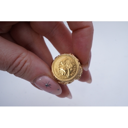 245 - A gold peso coin ring, set with a Mexican 2.5 peso coin dated 1945, in an elaborate gold mount of Ba... 