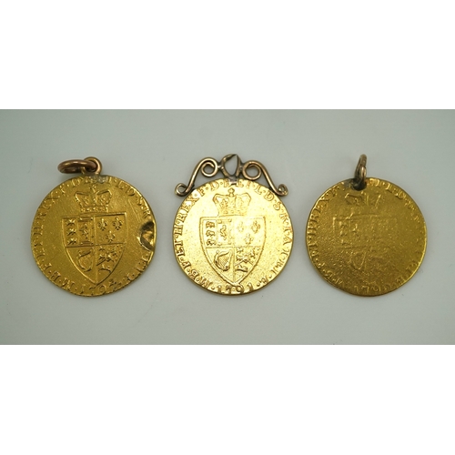 247 - Three George III gold spade guinea coin pendants, late 18th/early 19th century and later, the three ... 