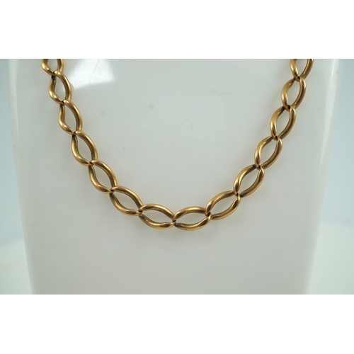 250 - An Edwardian gold Albert chain, early 20th century, of curb linking, each end with a hook clasp, len... 