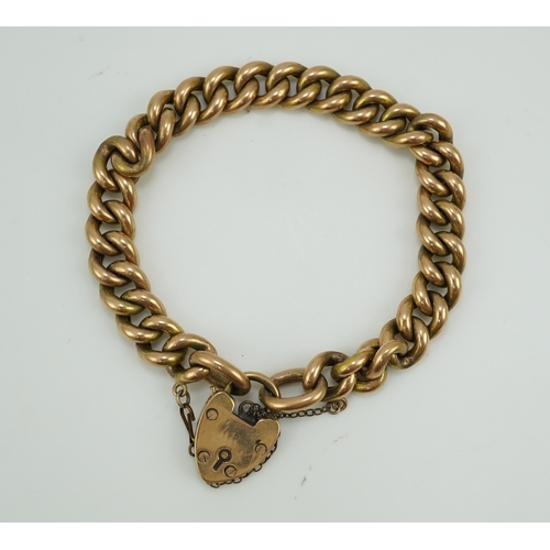 252 - An Edwardian gold bracelet, early 20th century, composed of curb linking, with heart shaped padlock ... 