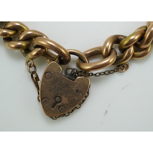 252 - An Edwardian gold bracelet, early 20th century, composed of curb linking, with heart shaped padlock ... 