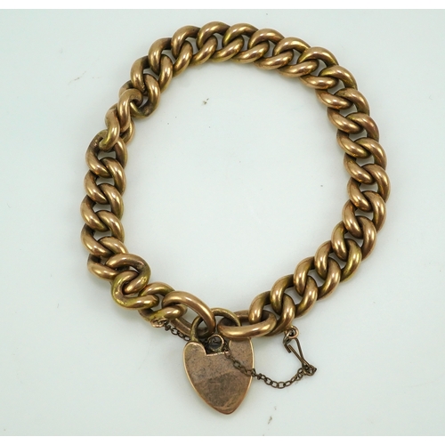 252 - An Edwardian gold bracelet, early 20th century, composed of curb linking, with heart shaped padlock ... 