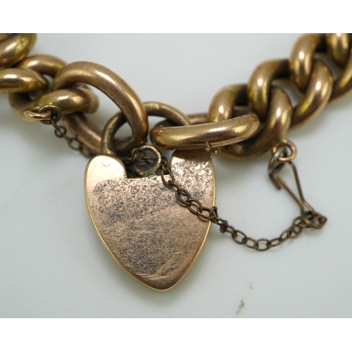 252 - An Edwardian gold bracelet, early 20th century, composed of curb linking, with heart shaped padlock ... 