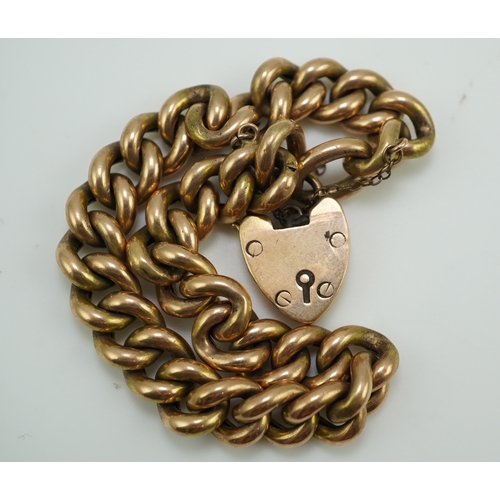 252 - An Edwardian gold bracelet, early 20th century, composed of curb linking, with heart shaped padlock ... 