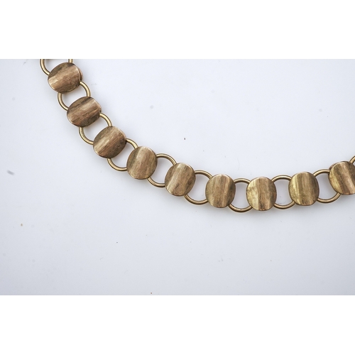 253 - A gold necklace, circa 2000, composed of textured 9ct gold linking, to a clasp accented with a brill... 