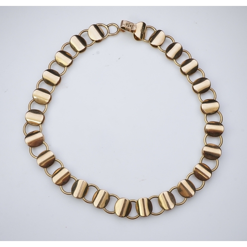 253 - A gold necklace, circa 2000, composed of textured 9ct gold linking, to a clasp accented with a brill... 