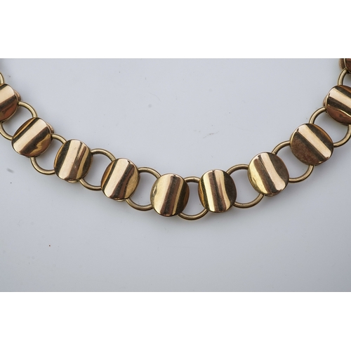 253 - A gold necklace, circa 2000, composed of textured 9ct gold linking, to a clasp accented with a brill... 