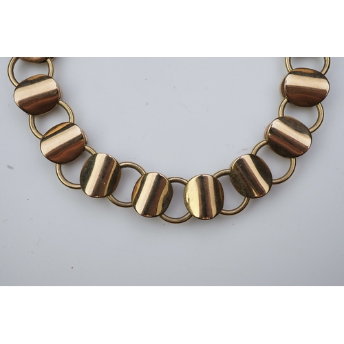 253 - A gold necklace, circa 2000, composed of textured 9ct gold linking, to a clasp accented with a brill... 