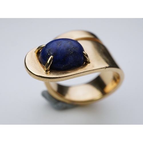 258 - Jean Dinh Van for Cartier, a lapis lazuli ring, circa 1970 designed as a tapered coil, claw-set with... 