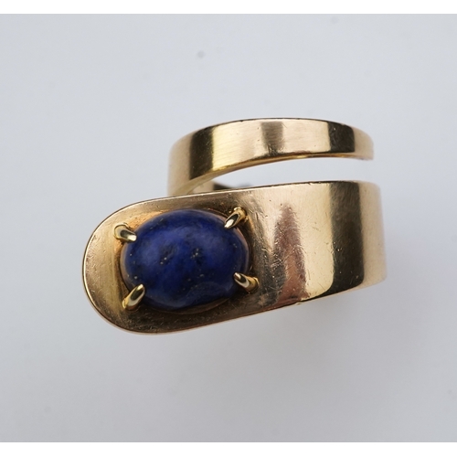 258 - Jean Dinh Van for Cartier, a lapis lazuli ring, circa 1970 designed as a tapered coil, claw-set with... 