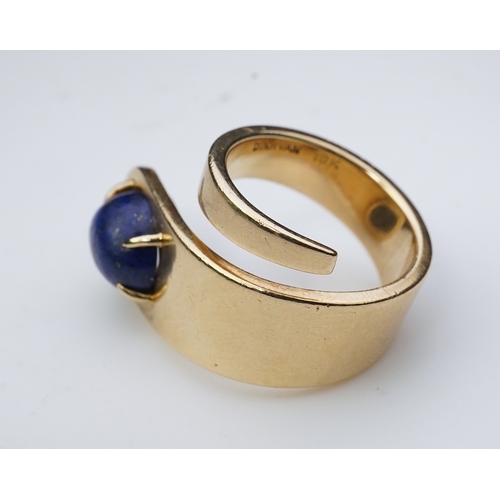 258 - Jean Dinh Van for Cartier, a lapis lazuli ring, circa 1970 designed as a tapered coil, claw-set with... 