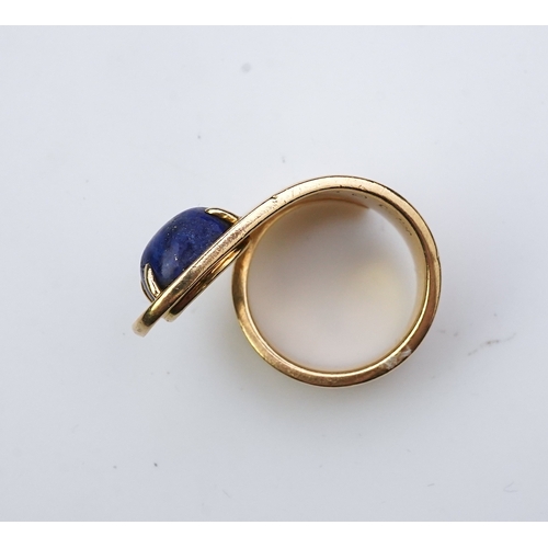 258 - Jean Dinh Van for Cartier, a lapis lazuli ring, circa 1970 designed as a tapered coil, claw-set with... 