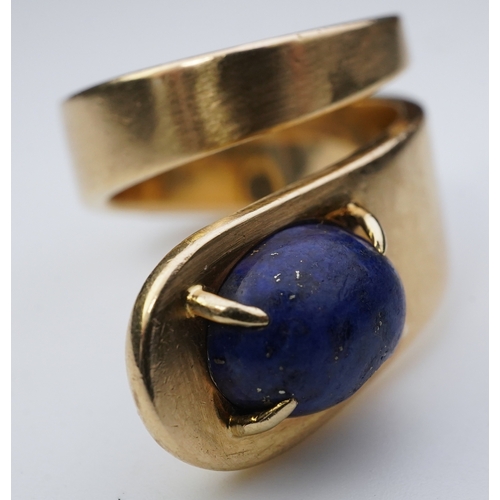 258 - Jean Dinh Van for Cartier, a lapis lazuli ring, circa 1970 designed as a tapered coil, claw-set with... 