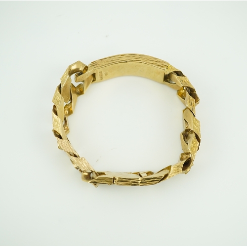 260 - A 9ct gold identity bracelet, circa 1973, composed of heavy curb linking with a textured finish, cen... 