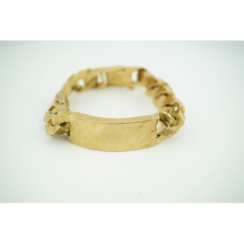 260 - A 9ct gold identity bracelet, circa 1973, composed of heavy curb linking with a textured finish, cen... 