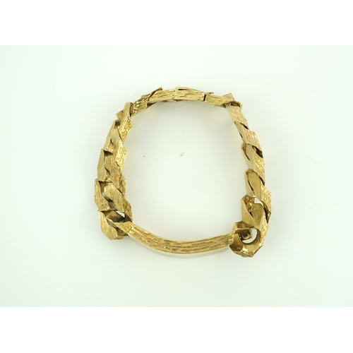 260 - A 9ct gold identity bracelet, circa 1973, composed of heavy curb linking with a textured finish, cen... 