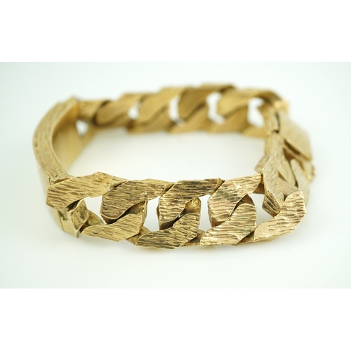 260 - A 9ct gold identity bracelet, circa 1973, composed of heavy curb linking with a textured finish, cen... 