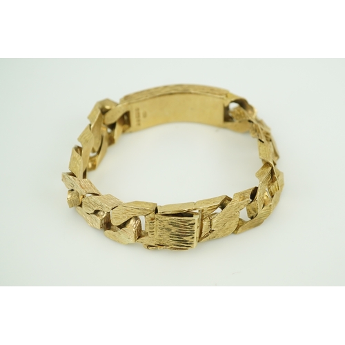 260 - A 9ct gold identity bracelet, circa 1973, composed of heavy curb linking with a textured finish, cen... 