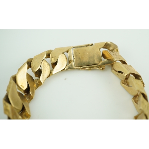 260 - A 9ct gold identity bracelet, circa 1973, composed of heavy curb linking with a textured finish, cen... 