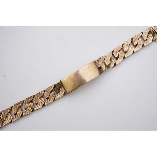 260 - A 9ct gold identity bracelet, circa 1973, composed of heavy curb linking with a textured finish, cen... 