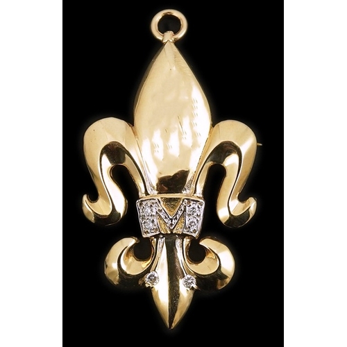 262 - A gold and diamond pendant/brooch, designed as a fleur-de-lis, the letter 'M' pavé-set with brillian... 