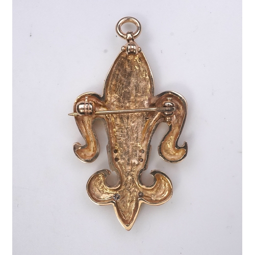 262 - A gold and diamond pendant/brooch, designed as a fleur-de-lis, the letter 'M' pavé-set with brillian... 