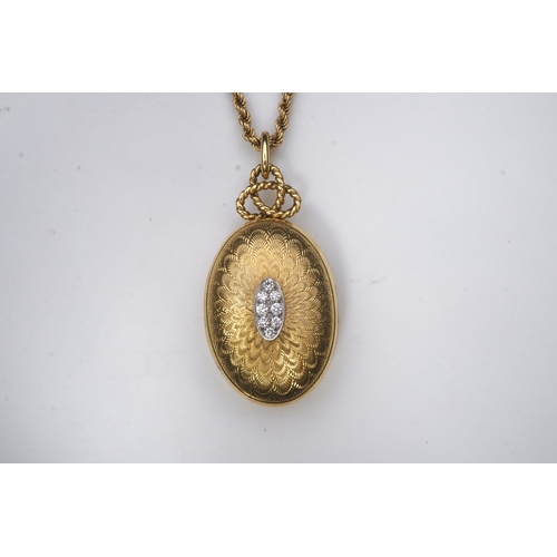 264 - Cartier, an 18ct gold and diamond locket pendant, 1978, the oval locket with engine turned decoratio... 