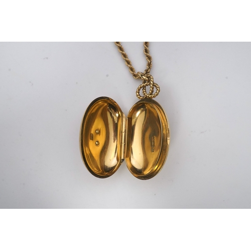 264 - Cartier, an 18ct gold and diamond locket pendant, 1978, the oval locket with engine turned decoratio... 