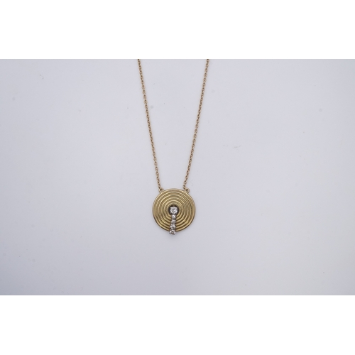 265 - An 18ct gold and diamond pendant, circa 1978, designed as a grooved disc set with a line of graduate... 