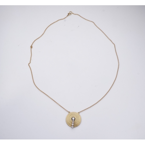 265 - An 18ct gold and diamond pendant, circa 1978, designed as a grooved disc set with a line of graduate... 