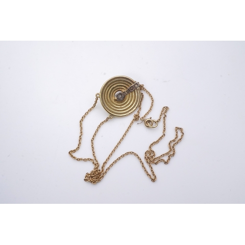 265 - An 18ct gold and diamond pendant, circa 1978, designed as a grooved disc set with a line of graduate... 