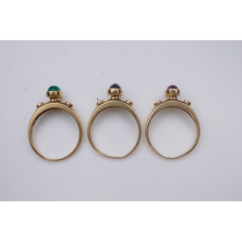 268 - A suite of three gold and gem-set rings, the three rings each set with a cabochon emerald, sapphire ... 