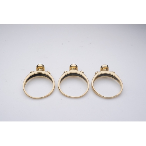 268 - A suite of three gold and gem-set rings, the three rings each set with a cabochon emerald, sapphire ... 