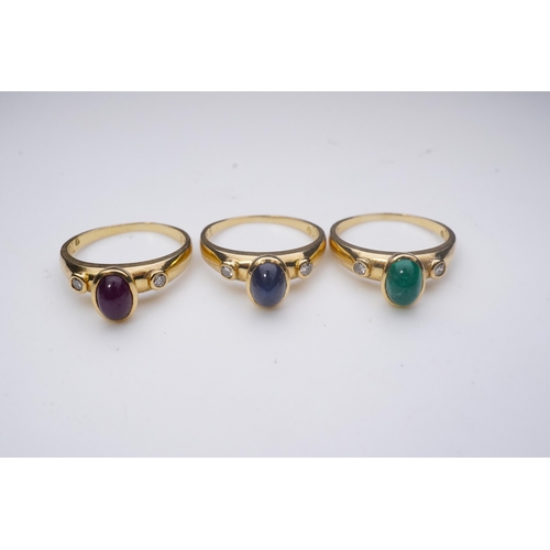 268 - A suite of three gold and gem-set rings, the three rings each set with a cabochon emerald, sapphire ... 